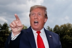 President Donald Trump speaks to reporters at the White House in Washington, July 24, 2019.