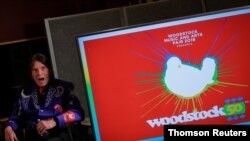 FILE - Singer John Fogerty speaks during the announcement event for the lineup for the Woodstock 50th Anniversary concert in New York.