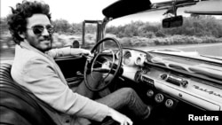 Bruce Springsteen is shown driving his 1957 Chevrolet Bel Air Convertible in this undated photo, referenced in his iconic song "Born to Run." The car is up for auction and is expected to fetch several hundred thousand dollars, photo provided Dec. 15, 2016. (Courtesy Eric Meola/Handout) 