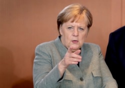 FILE - German Chancellor Angela Merkel attends a weekly cabinet meeting at the Chancellery in Berlin, Germany, Dec. 18, 2019.