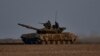 Ukrainian soldiers ride atop a tank on the frontline in Bakhmut, Donetsk region, Ukraine, March 22, 2023.