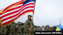 Servicemen of the U.S. and Ukrainian armies attend the opening ceremony of the "RAPID TRIDENT-2021" military exercise at Ukraine's International Peacekeeping Security Center near Yavoriv in the Lviv region, September 20, 2021. (Reuters/Gleb Garanich)