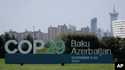 FILE - A motion   for COP29, the United Nations Climate Change Conference, is connected  show  successful  Baku, Azerbaijan, Sept. 16, 2024.