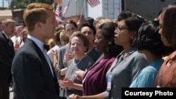 Katherine G. Johnson (Taraji P. Henson), flanked by fellow mathematicians Dorothy Vaughan (Octavia Spencer) and Mary Jackson (Janelle Monáe) meet the man they helped send into orbit, John Glenn (Glen Powell), in "Hidden Figures". 