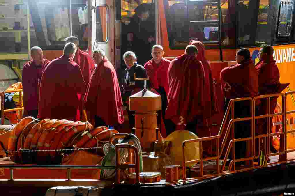 Survivors of the sinking of Russian cargo ship Ursa Major stand on the deck of a Spanish Maritime Rescue ship upon arrival at the port of Cartagena, Spain, Dec. 23, 2024.