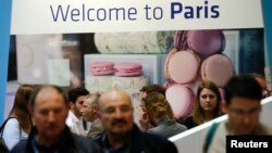 Visitors browse the exhibition stand of French capital Paris at the International Tourism Trade Fair (ITB) in in Berlin, Germany, March 9, 2016. 