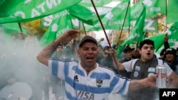 FILE - Workers demonstrate in Buenos Aires against the government's cuts in public expenditure and jobs, April 29, 2016. 