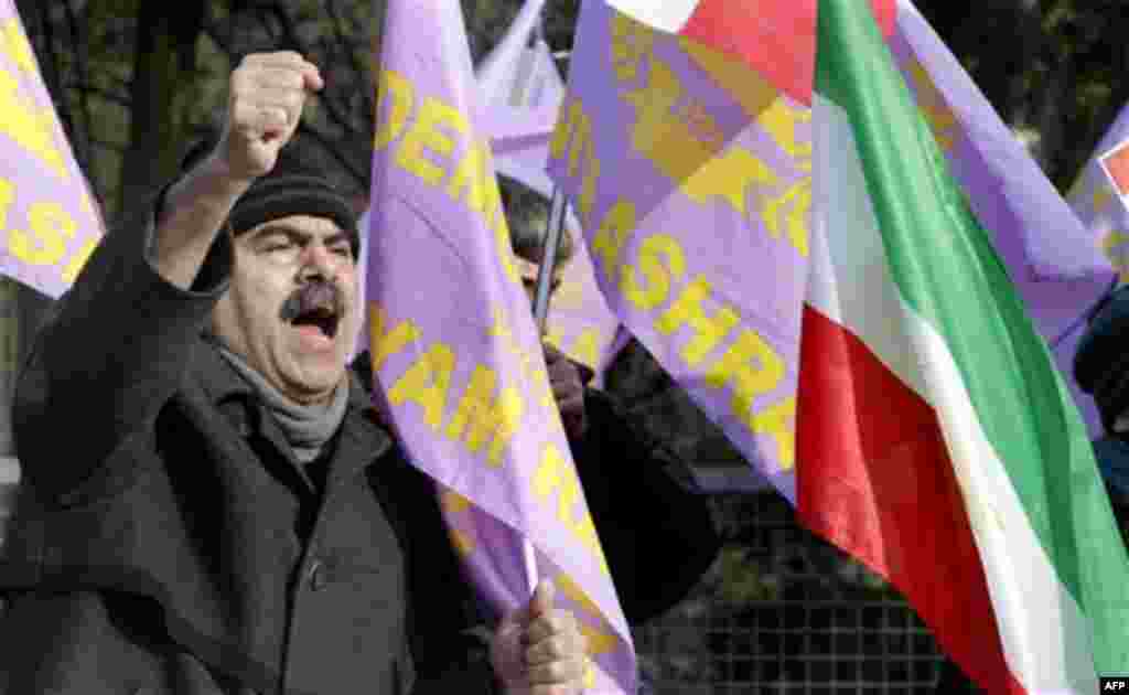 A man shouts slogans as some thirty activists of the Iranian Resistance Council demonstrate in front of the Iranian embassy in Berlin, Germany, Tuesday, Feb. 15, 2011. (AP Photo/Michael Sohn)