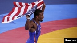 Jordan Burroughs of U.S. celebrates after defeating Iran's Sadegh Saeed Goudarzi in the final of the men's 74Kg freestyle wrestling at the ExCel venue during the London 2012 Olympic Games, August 10, 2012.