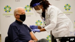 President-elect Joe Biden receives his first dose of the coronavirus vaccine at ChristianaCare Christiana Hospital in Newark, Del., Monday, Dec. 21, 2020, from nurse practitioner Tabe Mase.