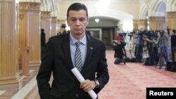 FILE - Romania's Prime Minister Sorin Grindeanu leaves a meeting at the parliament in Bucharest, Feb. 6, 2017.