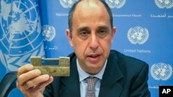 Tomas Ojea Quintana, the United Nations special investigator on human rights in North Korea, holds up a lock given to him by North Koreans who escaped from the country, during a press conference, Oct. 23, 2018, at U.N. headquarters in New York. 