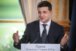 FILE - Ukrainian President Volodymyr Zelenskiy delivers a speech at the Elysee Palace, in Paris, June 17, 2019.