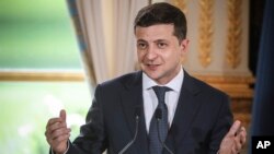 Ukrainian President Volodymyr Zelenskiy, delivers a speech during a press conference with French President Emmanuel Macron, at the Elysee Palace, in Paris, June 17, 2019.