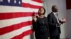 Deux Américains nouvellement naturalisés posent à côté d'un drapeau américain après avoir prêté serment lors d'une cérémonie spéciale au bureau des services de citoyenneté et d'immigration des États-Unis (USCIS) à Manhattan, New York, le 13 novembre 2015. REUTERS/Mike Segar
