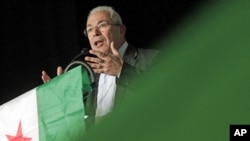 German Greens&#39; top candidate for the upcoming general elections Juergen Trittin is hidden behind a shrub as he speaks during a party convention in Bingen, western Germany.