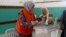 A Palestinian woman casts her ballot at a polling station during municipal elections in the northern West Bank town of Anabta, near Tulkarm, May 13, 2017.