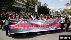 FILE - Members of Kenya's ruling Jubilee coalition demonstrate in support of the Independent Electoral and Boundaries Commission (IEBC) the electoral body ahead of next year's election in Nairobi, June 8, 2016. 