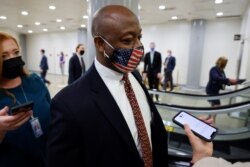 U.S. Senator Scott speaks with reporters as he transits the subway system beneath the U.S. Capitol in Washington