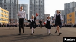 FILE - Pupils celebrate the beginning of a new school year during a ceremony marking Knowledge Day at a newly opened school in Saint Petersburg, Russia, Sept. 2, 2024.