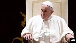 FILE - Pope Francis attends the traditional greetings to the Roman Curia, at the Vatican, Dec. 21, 2018.