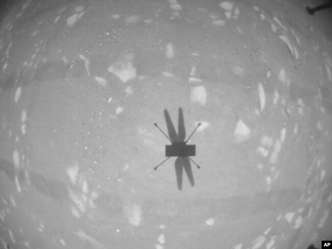 FILE - The Mars Ingenuity helicopter photographs its shadow with its black-and-white navigation camera during its second flight, in this image released by NASA on April 22, 2021.
