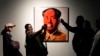 People take pictures next an Andy Warhol painting of China's late leader Mao Zedong at "Eye to Eye," an exhibit at the Tehran Museum of Contemporary Art in Iran, Nov. 21, 2024.