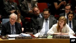 FILE - United Kingdom U.N. Ambassador Mark Lyall Grant, left, listens as Samantha Power, the U.S. ambassador to the United Nations, speaks during a meeting of the U.N. Security Council Monday, Dec. 22, 2014, at the United Nations headquarters. 