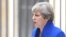 FILE - Britain's Prime Minister Theresa May makes a statement in Downing Street after traveling to Buckingham Palace to ask the Queen's permission to form a minority government, in London, June 9, 2017. 