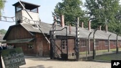 FILE - This file photo from July 29, 2016, shows the gate of the former German Nazi death camp of Auschwitz in Oswiecim, Poland. 