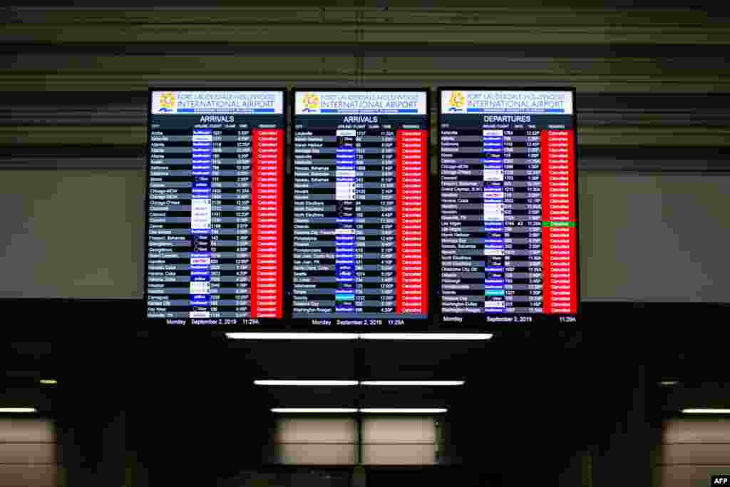 An information board displaying canceled flights is seen in the departure hall at Fort Lauderdale-Hollywood International Airport in Florida. The airport closed at noon due to a mandatory closure order as Hurricane Dorian approaches Florida. 
