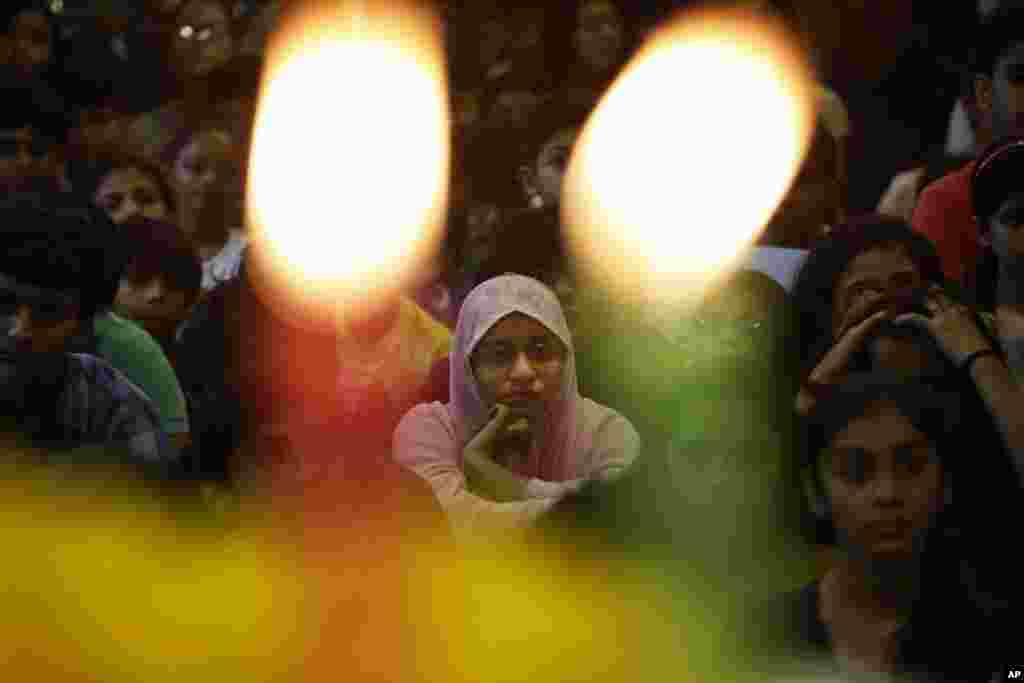 Indian school children attend a prayer ceremony in memory of victims of a truck attack in France, at a school in Ahmadabad, India, Friday, July 15, 2016.