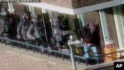 FILE - Police prepare for an operation in Arnhem, Netherlands, Sept. 27, 2018, in which seven men were arrested on suspicion of plotting an extremist attack. On Dec. 29, 2018, police said four suspects were detained in Rotterdam on suspicion of preparing a terrorist act.