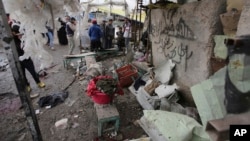 FILE - Citizens inspect the scene after a car bomb explosion at a crowded outdoor market in the Iraqi capital's eastern district of Sadr City, Iraq. UNAMI reported that 7,512 civilians were killed in Iraq in 2015. 