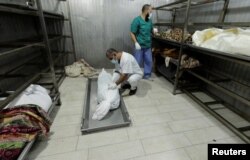 People view the bodies of Palestinians killed in an Israeli attack, in the morgue of Nasser Hospital, in the southern Gaza Strip.  (Photo: Reuters)