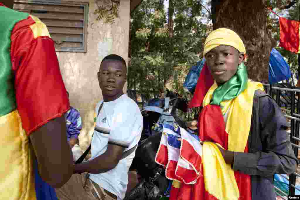 Young men sell homemade French and Malian flags at a junction in downtown Bamako, Mali.