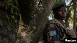 FILE - A Congolese soldier stands guard as he waits for the ceremony to repatriate the two bodies of South African soldiers killed in the ongoing war between M23 rebels and the Congolese army in Goma, North Kivu province of the Democratic Republic of Congo February 20, 2024.