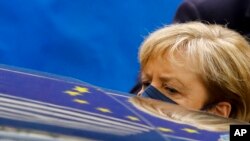 German Chancellor Angela Merkel departs after an EU summit in Brussels.