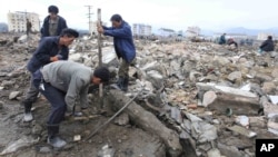 Workers recover cement blocks from flood-damaged areas in Onsong, North Korea, Sept. 16, 2016. 