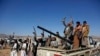 Houthi fighters and tribesmen stage a rally against the U.S. and the U.K. strikes on Houthi-run military sites near Sanaa, Yemen, on Jan. 14, 2024. 