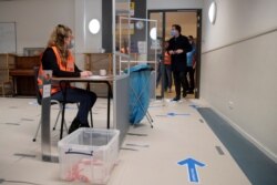 A box with discarded red voting pencils is seen in the foreground as Dutch caretaker Prime Minister Mark Rutte enters to cast his vote in a general election in The Hague, Netherlands, March 17, 2021.