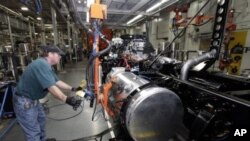 Thomas Warren installs a fuel cell on a Freightliner truck at a plant where the laid off workers will be called back to work to meet increasing demand, Cleveland, N.C., January 12, 2012.