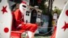 Abdou Khadre Diop, dressed as Santa Claus, waits for children to visit at Patisseries des Ambassades in Dakar, Senegal, Dec. 19, 2019. (Annika Hammerschlag/VOA)