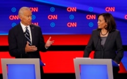 FILE - Sen. Kamala Harris, D-Calif., listens as former Vice President Joe Biden speaks during the second of two Democratic presidential primary debates hosted by CNN, July 31, 2019, in the Fox Theatre in Detroit.