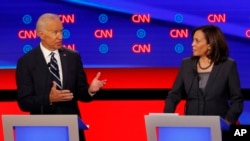 Sen. Kamala Harris, D-Calif., listens as former Vice President Joe Biden speaks during the second of two Democratic presidential primary debates hosted by CNN, July 31, 2019, in the Fox Theatre in Detroit.