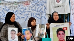 FILE - Families of people from al-Hansha in Tunisia's Sfax province who went missing at sea in irregular migration attempts, call on the government to find out what happened to their relatives during a rally in Tunis on February 6, 2024.