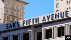 A Saks Fifth Avenue sign is shown in San Francisco, California, March 17, 2024. Saks' parent company announced on July 4, 2024, that it has signed a deal to purchase the Neiman Marcus Group.