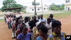 Votera wait in line in front of a polling station on December 17, 2011 in Mouila. Turnout was low as Gabon voted in legislative elections boycotted by part of the opposition in the west African oil state.