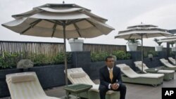 Former Maldives President Mohamed Nasheed poses for a picture at the poolside of a hotel in New Delhi, India, April 18, 2012.