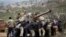 People film a shower of cherry blossoms at a park in Tokyo, Japan.